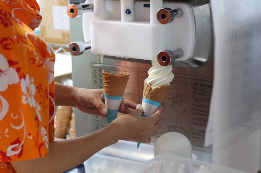 Two Ice-cream in Cones in the making by a Vendor Vanilla Flavor