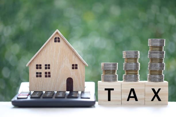 istock Fixed Rate,Model house on calculator with stack of coins money on natural green background, Calculating interest payments and Property tax concept 1448145283