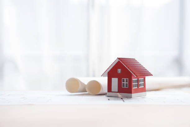 istock Red color House toy model with Solar Powered, engineering architect blueprint, Solar and Green Energy concept. 1448145699