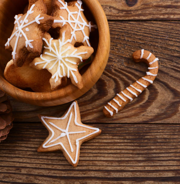 istock Home made Christmas sweets on brown wooden kitchen table. Selective focus. New Year cookies with holidays decorations. Copy space and blank template backdrop. 1448146725