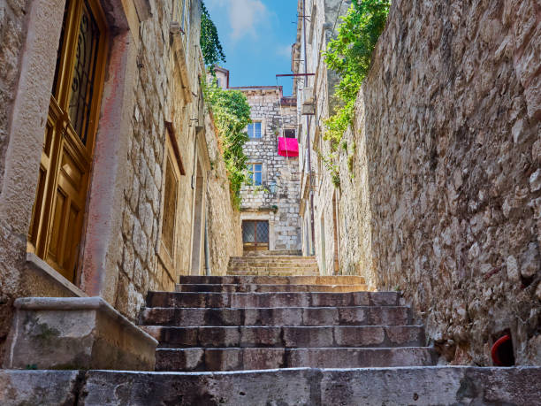 Stone steep street with steps in Dubrovnik Old Town in a sunny summer day. Croatia, Europe