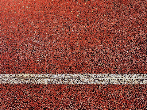 Tennis surface texture with white line. Rough Backgrounds and Textures. Close up of hard tennis court. Racket sports.