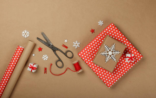 istock Packing Christmas gifts with red paper 1448150083