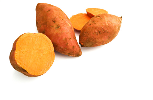 Sweet potatoes on a white background. Sweet potatoes cut up.