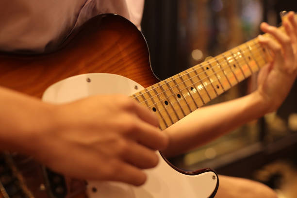 Selective focus on playing hand of rock guitarist