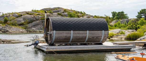 Barrel shaped sauna on a raft.. Gothenburg, Sweden - July 24 2022: Barrel shaped sauna on a raft. swedish sauna stock pictures, royalty-free photos & images