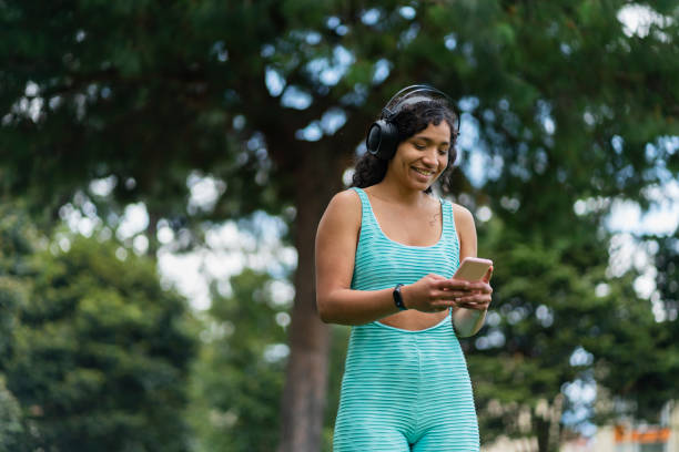 istock Sporty woman using phone 1448152464
