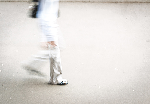 woman white dressed walking street, blurry motion