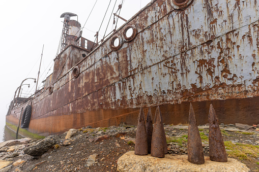 Old, rusty whaling ships and processing facilities at a now abandoned whaling station in Grytviken -on the island of South Georgia.