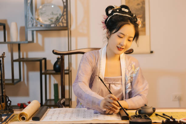 istock Asian Hanfu beauties use tablet computers to draw with brushes 1448157108