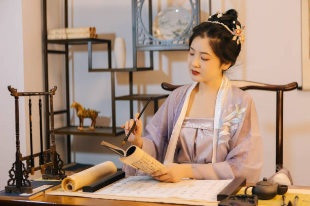 istock Asian Hanfu beauties use tablet computers to draw with brushes 1448157131