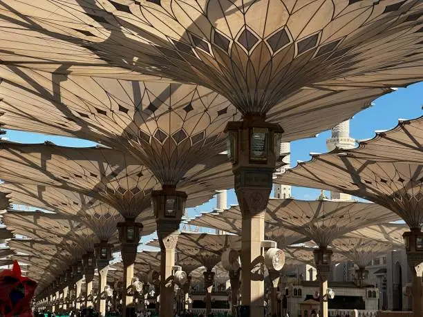 Nabawi mosque umbrella in the afternoon with beautiful shadow of sun