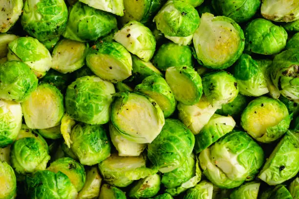 Close up of Brussels sprouts cut in half and tossed in olive oil, salt and pepper