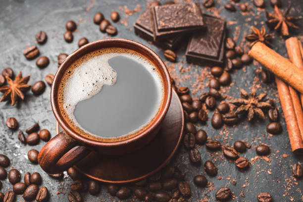 istock Fresh brewed black coffee in a cup on dark background with coffee beans and chocolate pieces 1448157538