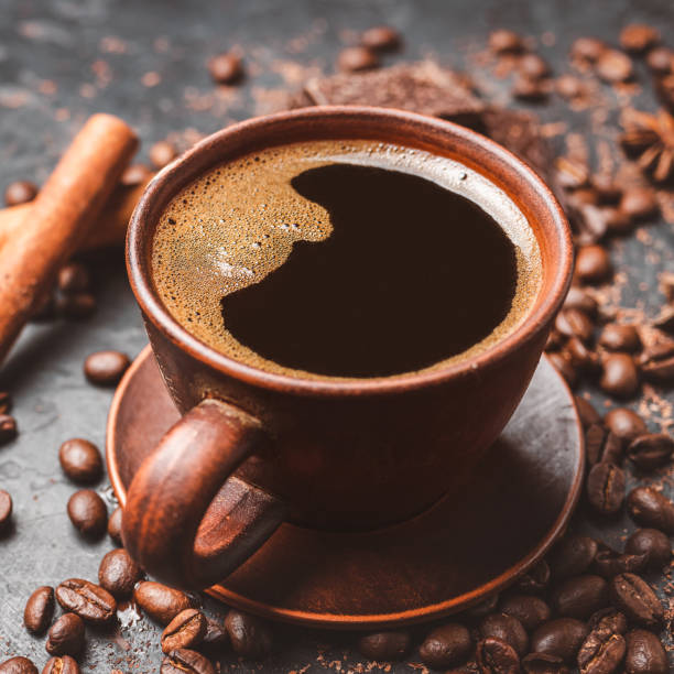 istock Fresh brewed black coffee in a cup on dark background with coffee beans and chocolate pieces 1448157539