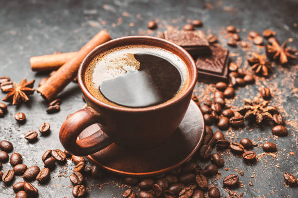 istock Fresh brewed black coffee in a cup on dark background with coffee beans and chocolate pieces 1448157542