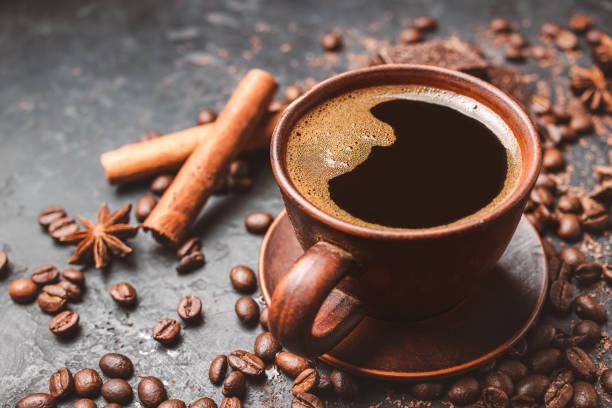 istock Fresh brewed black coffee in a cup on dark background with coffee beans and chocolate pieces 1448157547