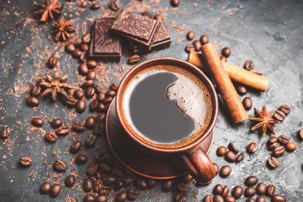 istock Fresh brewed black coffee in a cup on dark background with coffee beans and chocolate pieces 1448157550