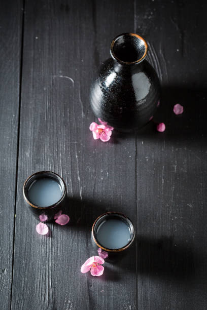 istock Unique Japanese sake with blooming pink flowers. 1448160827