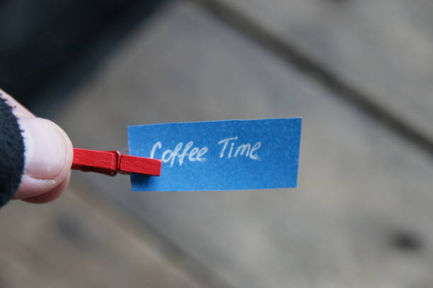 istock Coffee time inscription on a tag on a wooden background. 1448161138