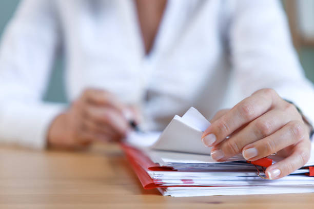 Human resources manager reading job applications in office