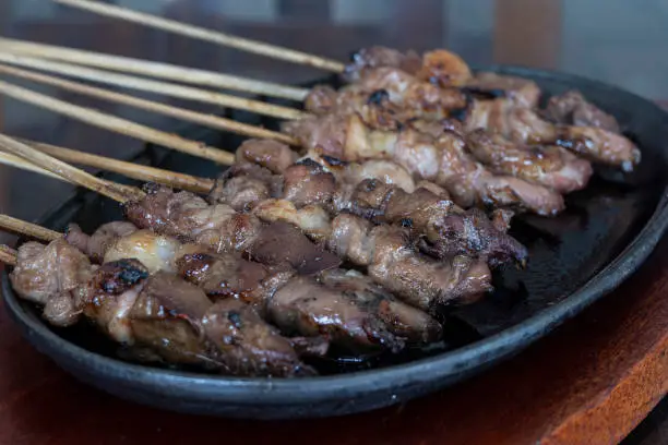 Photo of Indonesian lamb satay served on iron hot plate