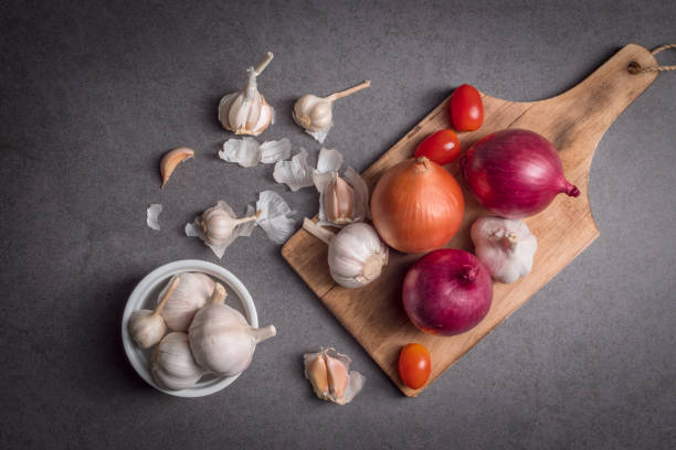 istock Herb and spice Concept. Garlic onion  set on chopping board. Food ingredients. 1448164657