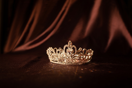 Elegance luxury royal crown on satin, silk background