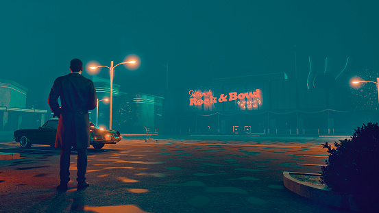 Cinematic film noir concept with man alone at parking lot