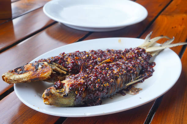 Bandeng kropok, Fried milk fish with spicy chilisauce and shrimp paste stock photo