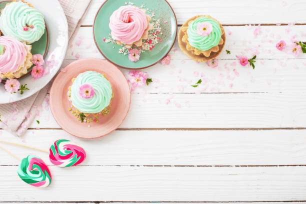 istock easter background with cupcakes, lollipops and spring flowers 1448170267