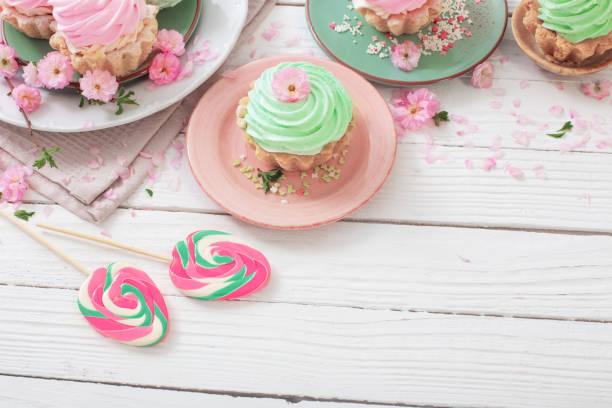 istock easter background with cupcakes, lollipops and spring flowers 1448170269