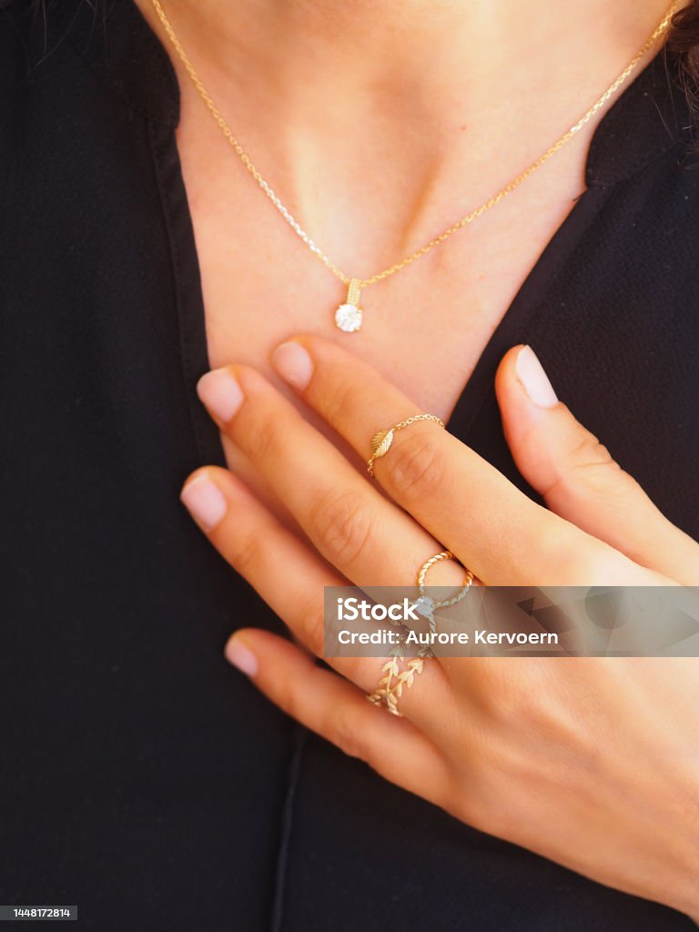 Diamond Gold rings on a woman hand Gold ring and bracelet on a woman hand Jewelry Stock Photo