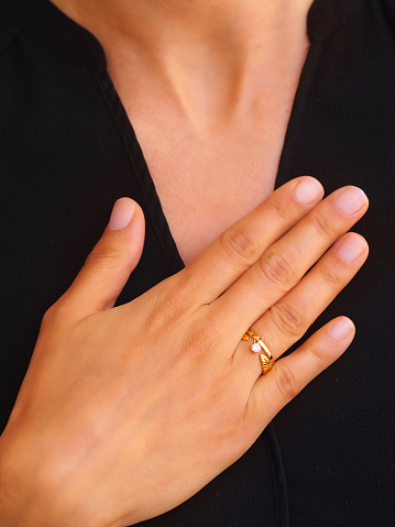 Gold ring and bracelet on a woman hand