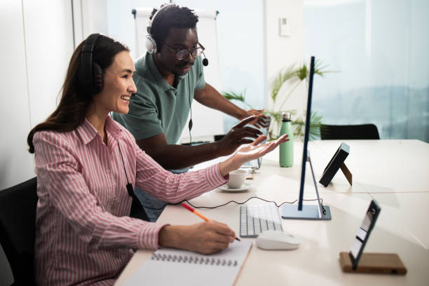 istock African American man and his Asian colleague solving some business problem 1448173739