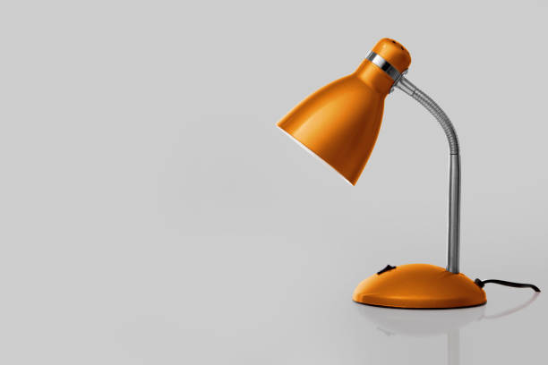 istock Orange desk lamp on gray background 1448178036