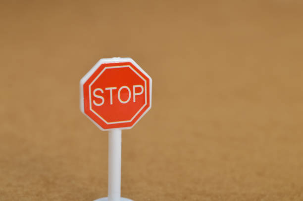 istock Stop sign symbol isolated on a brown background. 1448178137