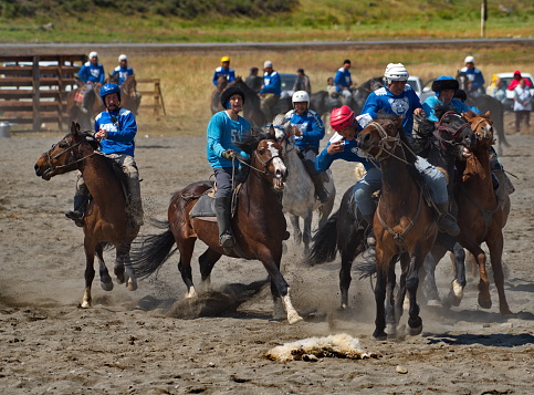 Kupchegen. Russia. May 14, 2021. Altai National Equestrian Game Kok-Boru. The moment of the fight of the players on horses for a sports equipment in the form of a goat carcass (ulah) weighing 35 kg.