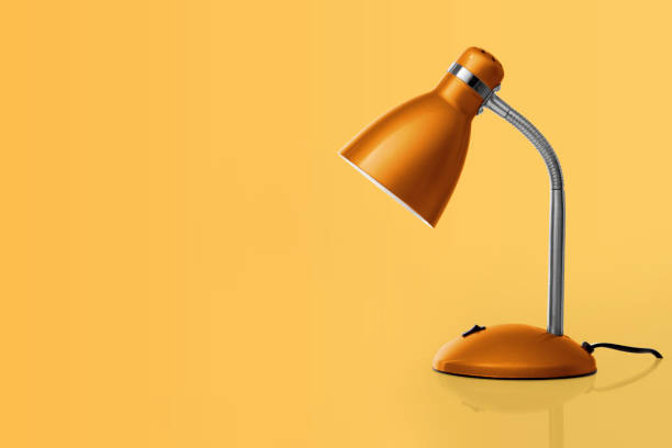 istock Orange desk lamp on light-orange background 1448178269
