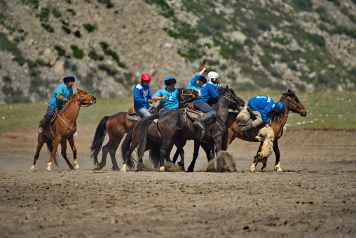 Kupchegen. Russia. May 14, 2021. Altai National Equestrian Game Kok-Boru. The moment of the fight of the players on horses for a sports equipment in the form of a goat carcass (ulah) weighing 35 kg.