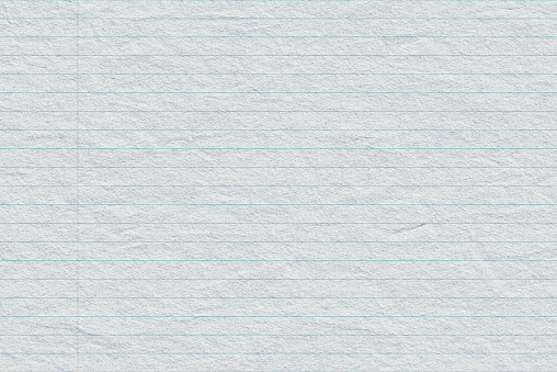Close-up of torn wrinkled lined notebook paper