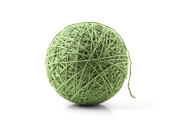 istock Green big cotton thread ball isolated on white background. 1448183573