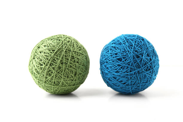 istock Two big thread balls green and blue isolated on white background. 1448183593