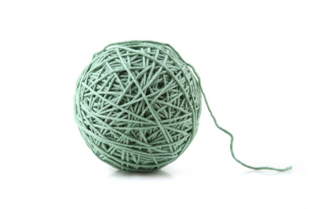 istock Green cotton thread ball isolated on white background. 1448183732