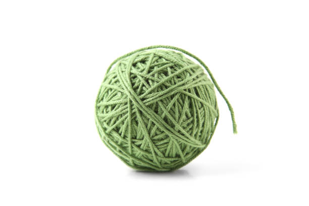 istock Green cotton thread ball isolated on white background. 1448183745