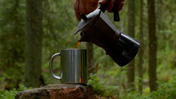 istock Coffee is poured into a mug from a coffee maker 1448184117