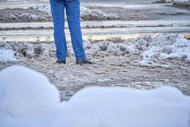 istock A man stands in front of the road during slush 1448189325