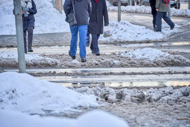 istock A man stands in front of the road during slush 1448189328