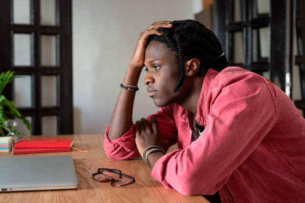 istock Upset young african guy remote worker coping with freelance burnout, sitting at desk with laptop 1448189630