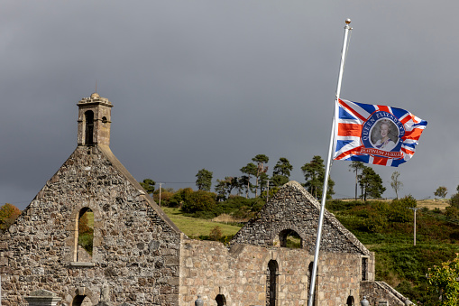 Methlick, Scotland September 16, 2022 : Flags at half mast after the death of Queen Elizabeth II in Methlick, a village in the Formartine region of Aberdeenshire